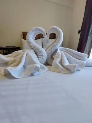 two towel swans sitting on top of a bed at Apartman Mile High -N Lux 90a Milmari Kopaonik in Kopaonik