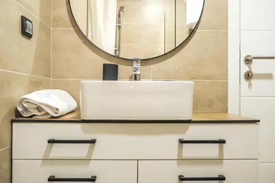 a bathroom with a sink and a mirror at Milmari Apartments Pahulja N Lux in Kopaonik