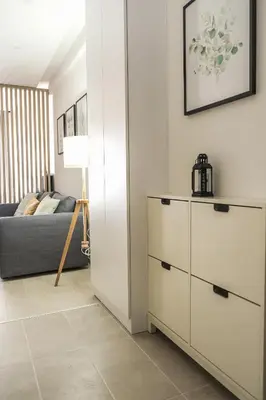 a living room with a dresser and a couch at Milmari Apartments Pahulja N Lux in Kopaonik