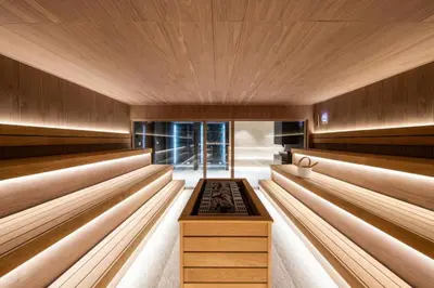 a sauna with wood paneling and a wooden ceiling at Woodside Story in Kopaonik