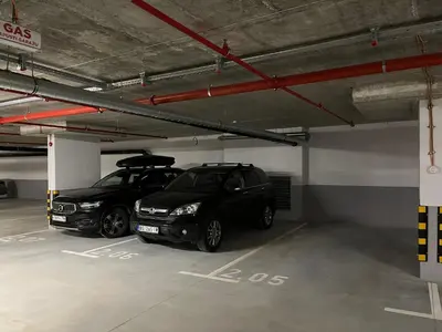 two cars are parked in a parking garage at Woodside Story in Kopaonik