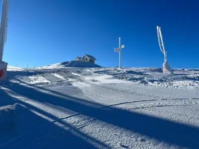 a shadow of a cross on a snow covered hill at Woodside Story in Kopaonik