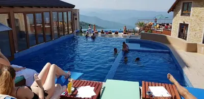 a group of people sitting in a swimming pool at Nest studio Milmari Kopaonik in Kopaonik