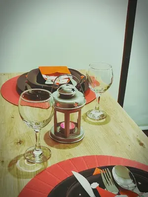 a wooden table with two wine glasses on it at Nest studio Milmari Kopaonik in Kopaonik