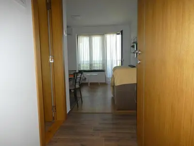 a room with a bed and a room with a table at Apartman Katarina in Soko Banja