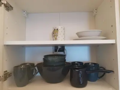 a shelf with pots and pans in a kitchen at BELVEDERE A9 ( N LUX MILMARI RESORT) in Kopaonik
