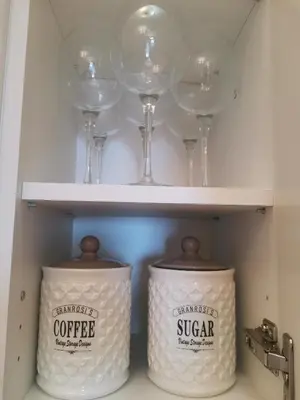 two wine glasses and two rolls of coffee in a pantry at BELVEDERE A9 ( N LUX MILMARI RESORT) in Kopaonik