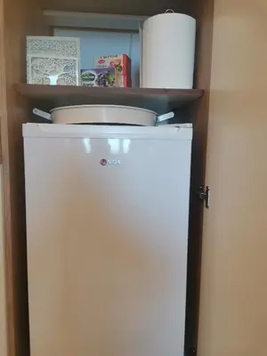 a white refrigerator with a toilet on top of it at BELVEDERE A9 ( N LUX MILMARI RESORT) in Kopaonik