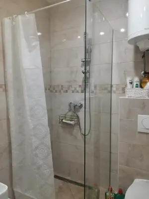 a shower with a glass door in a bathroom at BELVEDERE A9 ( N LUX MILMARI RESORT) in Kopaonik