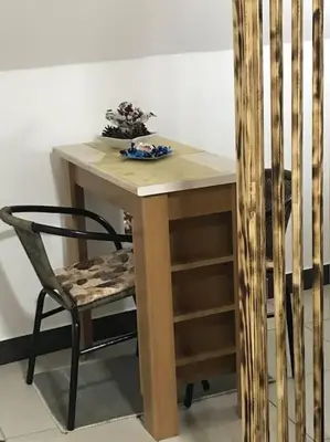 a wooden table with a chair and a table at APARTMAN Pahuljica in Kruševac