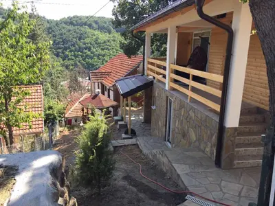 a house with a balcony with a view of a mountain at Stari Hrast 2 in Prolomska Banja