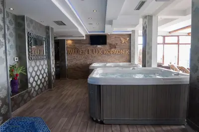 a bathroom with a large tub in a room at Apartman B 8 - Lapčević u zgradi MUJEN LUX, Kopaonik in Kopaonik