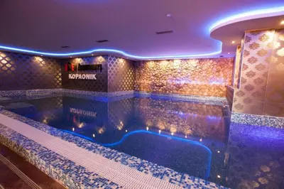 a large swimming pool in a hotel room at Apartman B 8 - Lapčević u zgradi MUJEN LUX, Kopaonik in Kopaonik