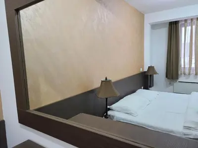 a bedroom with a bed with a large mirror at Apartman B 8 - Lapčević u zgradi MUJEN LUX, Kopaonik in Kopaonik