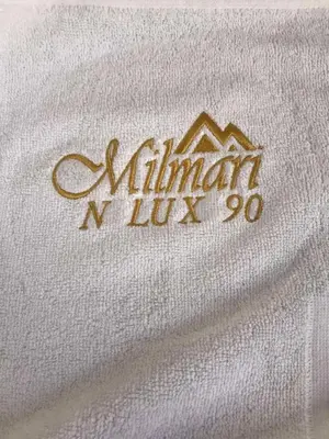 a white shirt with a mountain logo on it at Kopaonik Milmari & Spa N Lux 90 in Kopaonik
