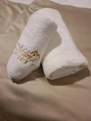 a pair of white socks sitting on top of a bed at Kopaonik Milmari & Spa N Lux 90 in Kopaonik