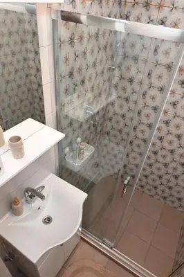 a bathroom with a sink and a shower at Apartman Krinka in Vrnjačka Banja