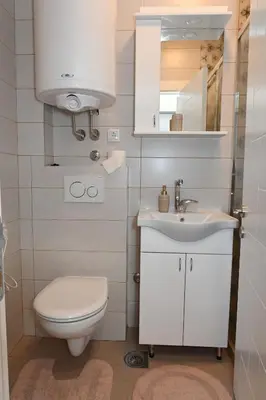 a small bathroom with a toilet and a sink at Apartman Krinka in Vrnjačka Banja