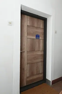 a wooden door with a sign on it at Apartman Krinka in Vrnjačka Banja