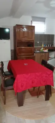 a kitchen with a table with a red table cloth on it at Konak Šarac in Crni Vrh