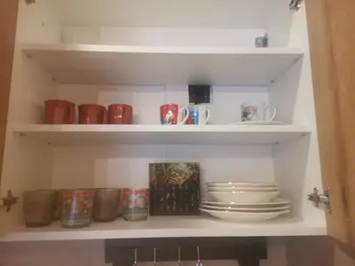 a shelf with plates and mugs on it at Golden Mountain A75 NLux Milmari in Kopaonik