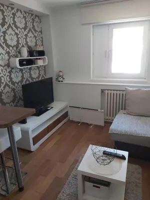 a living room with a television and a couch at MR. O Apartments Kopaonik in Kopaonik