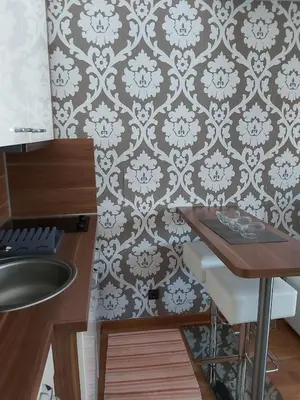 a bathroom with a sink and a table and a wall at MR. O Apartments Kopaonik in Kopaonik