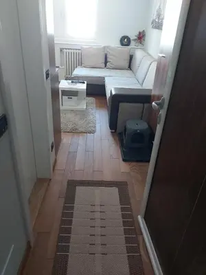 a small living room with a couch and a table at MR. O Apartments Kopaonik in Kopaonik
