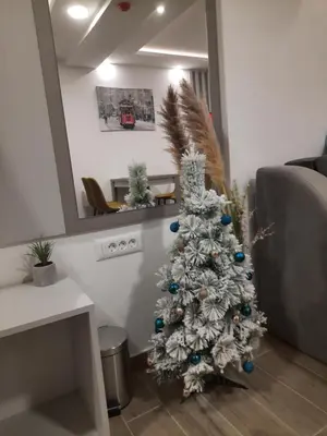a white christmas tree in a living room at Apartman A20B in Kopaonik