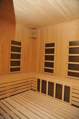 an empty sauna with wooden walls and ceilings at Apartman A20B in Kopaonik