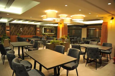 a restaurant with tables and chairs in a room at Apartman A20B in Kopaonik