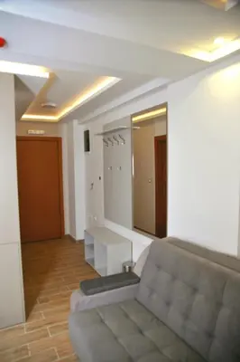 a living room with a couch and a mirror at Apartman A20B in Kopaonik