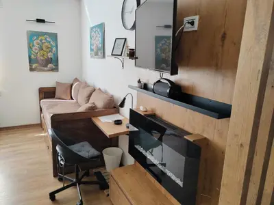 a living room with a couch and a table at Start Apartments LUX KOPAONIK in Kopaonik