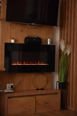a fireplace in a living room with a tv at Start Apartments LUX KOPAONIK in Kopaonik