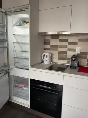 a kitchen with a stove and an empty refrigerator at Sunčani Breg Resort&Spa Kopaonik, Apartman broj 409 in Kopaonik