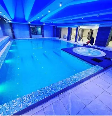 a large swimming pool with a person in the middle at Sunčani Breg Resort&Spa Kopaonik, Apartman broj 409 in Kopaonik