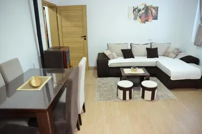 a living room with a couch and a table at Apartmani Moskva in Kopaonik