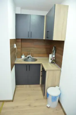 a small kitchen with a sink and a toilet at Apartmani Moskva in Kopaonik