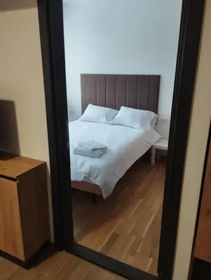 a mirror reflection of a bed in a bedroom at Sunčana Planina Kopaonik in Kopaonik