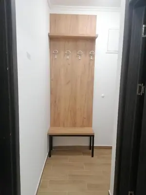 a locker room with a wooden door and a bench at Sunčana Planina Kopaonik in Kopaonik