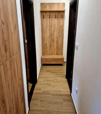 a hallway with a wooden door and a wooden floor at Sunčana Planina Kopaonik in Kopaonik