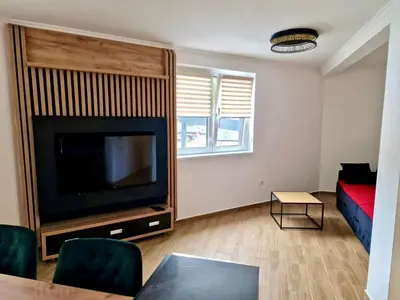 a living room with a flat screen tv and a couch at Sunčana Planina Kopaonik in Kopaonik