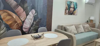 a living room with a table and a couch at Apartman Vukota 2 Pirot in Pirot
