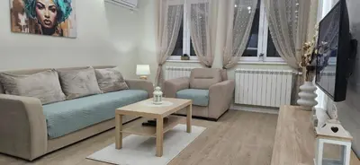a living room with a couch and a chair and a table at Apartman Vukota 2 Pirot in Pirot