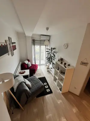 a living room with a couch and a table at Apartman-Stefanovic in Vranje