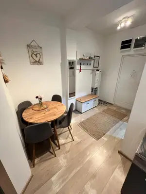 a kitchen and dining room with a table and chairs at Apartman-Stefanovic in Vranje