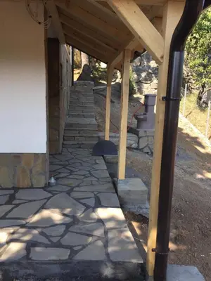 a stone walkway under a wooden pergola at Stari Hrast 1 in Prolomska Banja