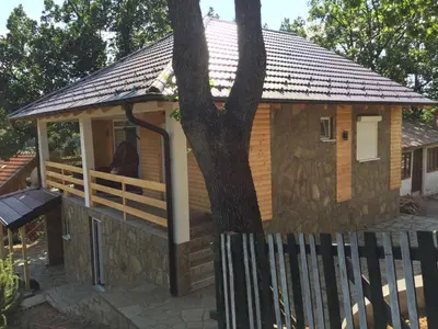 a small cabin with a tree in the window at Stari Hrast 1 in Prolomska Banja