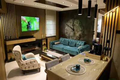 a living room with a blue couch and a tv at Design Apartment PLATINIUM SPA LUX 5 STAR 