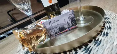 a table with a plate with a cake and a glass at Design Apartment PLATINIUM SPA LUX 5 STAR 